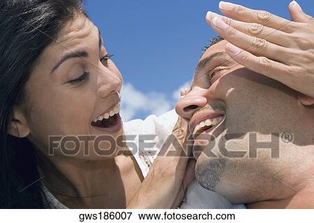 Close-up of a mid adult couple smiling View Large Photo Image Stock Photo - Close-up of a mid adult couple smiling. Fotosearch