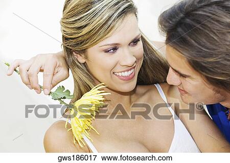 Close-up of a young couple looking at each other and smiling View Large Photo Image Stock Photo - Close-up of a young couple looking at each other and smiling. Fotosearch