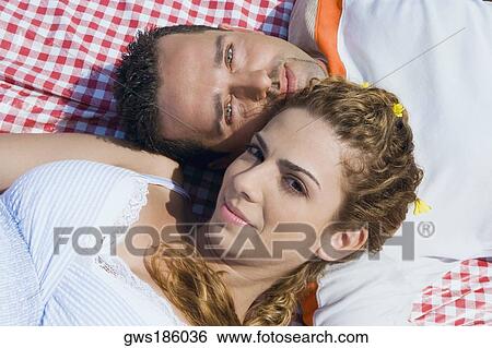 High angle view of a mid adult couple lying on a picnic blanket View Large Photo Image Stock Photograph - High angle view of a mid adult couple lying on a picnic blanket. Fotosearch
