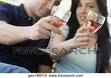 Portrait of a mid adult man and a young woman holding wine glasses View Large Photo Image Stock Photo - Portrait of a mid adult man and a young woman holding wine glasses. Fotosearch