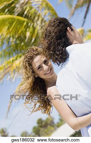 Portrait of a mid adult woman walking with her arm around a mid adult man and smiling View Large Photo Image Stock Image - Portrait of a mid adult woman walking with her arm around a mid adult man and smiling. Fotosearch