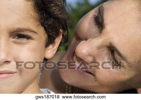 Close-up of a mid adult woman looking at her son View Large Photo Image Stock Photo - Close-up of a mid adult woman looking at her son. Fotosearch
