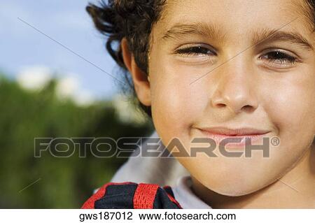 Stock Image - Portrait of a boy smirking. Fotosearch