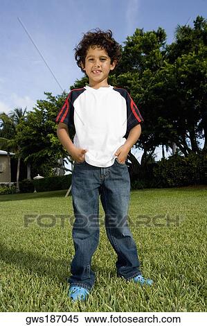 Portrait of a boy standing in a lawn View Large Photo Image Stock Photography - Portrait of a boy standing in a lawn. Fotosearch