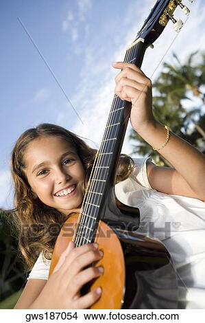 Portrait of a girl playing a guitar View Large Photo Image Picture - Portrait of a girl playing a guitar. Fotosearch