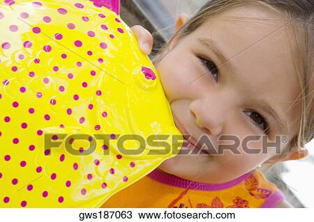 Portrait of a girl playing with a fish toy View Large Photo Image Stock Image - Portrait of a girl playing with a fish toy. Fotosearch