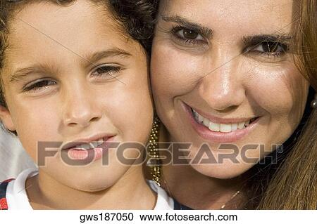 Portrait of a mid adult woman and her son smiling View Large Photo Image Stock Image - Portrait of a mid adult woman and her son smiling. Fotosearch