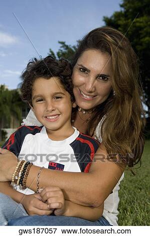 Portrait of a mid adult woman hugging her son View Large Photo Image Stock Photo - Portrait of a mid adult woman hugging her son. Fotosearch