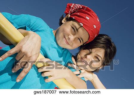 Portrait of a mid adult woman smiling with his son View Large Photo Image Stock Photo - Portrait of a mid adult woman smiling with his son. Fotosearch