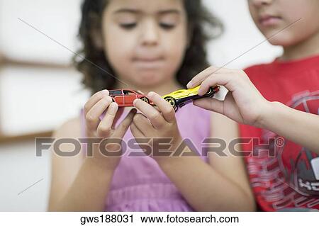 Close-up of a boy with his sister playing with toy cars View Large Photo Image Stock Image - Close-up of a boy with his sister playing with toy cars. Fotosearch