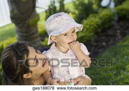 Girl smiling with her mother View Large Photo Image Stock Photo - Girl smiling with her mother. Fotosearch