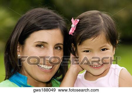 Portrait of a girl smiling with her mother View Large Photo Image Stock Photo - Portrait of a girl smiling with her mother. Fotosearch