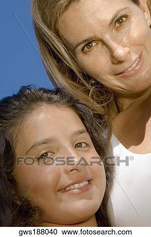 Portrait of a mature woman smiling with her daughter View Large Photo Image Stock Image - Portrait of a mature woman smiling with her daughter. Fotosearch