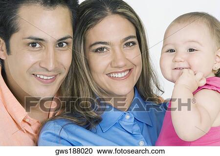 Portrait of a young couple with their daughter smiling View Large Photo Image Stock Image - Portrait of a young couple with their daughter smiling. Fotosearch
