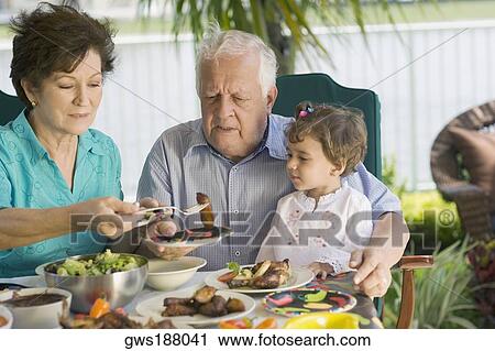 Senior couple having lunch with their granddaughter View Large Photo Image Stock Image - Senior couple having lunch with their granddaughter. Fotosearch