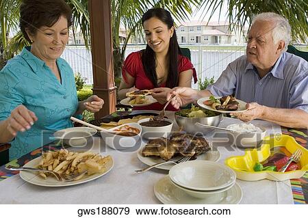 Senior couple having lunch with their granddaughter View Large Photo Image Stock Photo - Senior couple having lunch with their granddaughter. Fotosearch