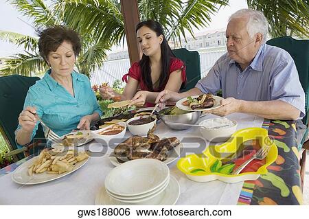 Senior couple having lunch with their granddaughter View Large Photo Image Stock Photograph - Senior couple having lunch with their granddaughter. Fotosearch