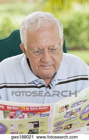 Senior man reading a newspaper View Large Photo Image Stock Image - Senior man reading a newspaper. Fotosearch