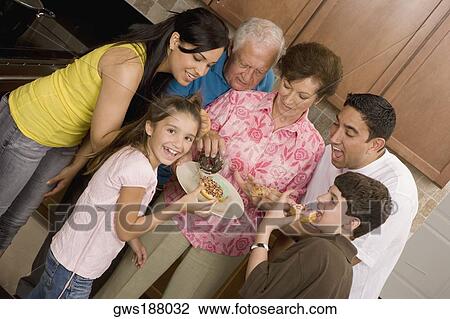 Three generation family eating food from a plate and smiling View Large Photo Image Stock Image - Three generation family eating food from a plate and smiling. Fotosearch