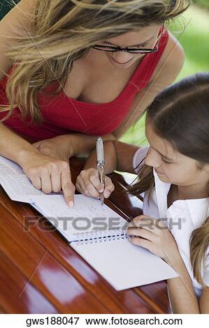 Young woman teaching a girl View Large Photo Image Stock Photo - Young woman teaching a girl. Fotosearch