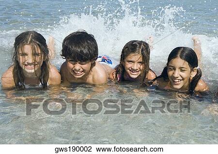 Boy and three girls swimming in the sea View Large Photo Image Stock Image - Boy and three girls swimming in the sea. Fotosearch