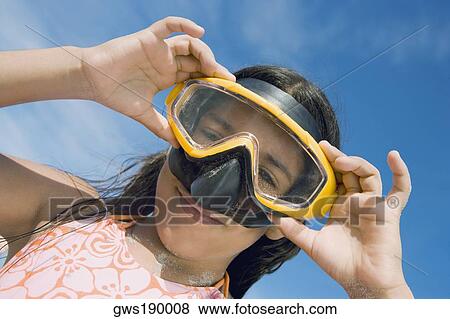 Low angle view of a girl wearing a scuba mask View Large Photo Image Stock Photo - Low angle view of a girl wearing a scuba mask. Fotosearch