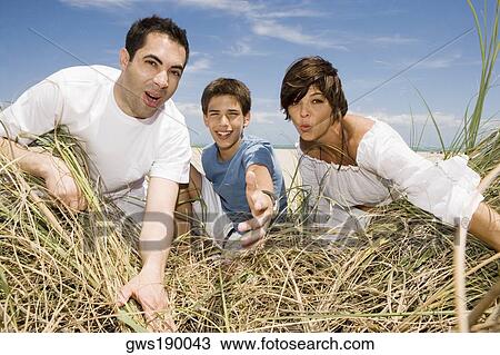 Mid adult couple with their son playing on the beach View Large Photo Image Stock Image - Mid adult couple with their son playing on the beach. Fotosearch