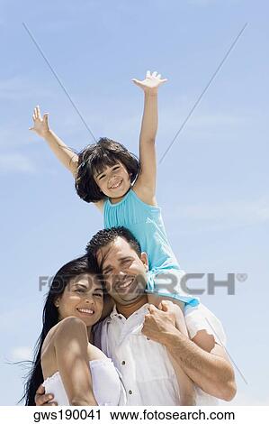 Mid adult man carrying his daughter on his shoulders with a mid adult woman beside them View Large Photo Image Stock Image - Mid adult man carrying his daughter on his shoulders with a mid adult woman beside them. Fotosearch