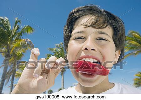 Portrait of a boy eating an ice-cream View Large Photo Image Stock Photography - Portrait of a boy eating an ice-cream. Fotosearch