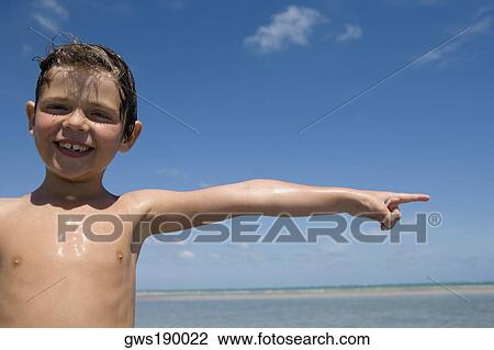 Portrait of a boy pointing and smiling View Large Photo Image Stock Image - Portrait of a boy pointing and smiling. Fotosearch