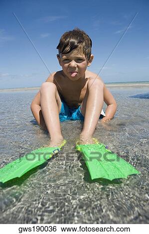 Portrait of a boy wearing flippers and sticking his tongue out View Large Photo Image Stock Photograph - Portrait of a boy wearing flippers and sticking his tongue out. Fotosearch
