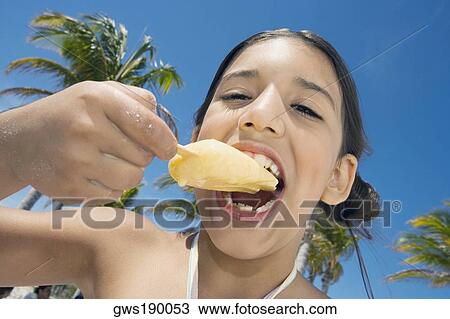 Portrait of a girl eating an ice-cream View Large Photo Image Stock Image - Portrait of a girl eating an ice-cream. Fotosearch