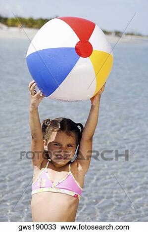 Portrait of a girl holding a beach ball on the beach View Large Photo Image Stock Image - Portrait of a girl holding a beach ball on the beach. Fotosearch
