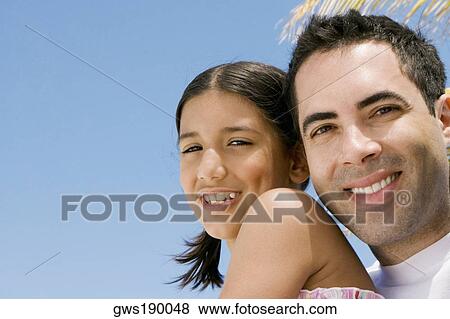 Portrait of a mid adult man and his daughter smiling View Large Photo Image Stock Photo - Portrait of a mid adult man and his daughter smiling. Fotosearch