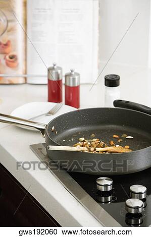 Close-up of a frying pan on a stove in the kitchen View Large Photo Image Stock Image - Close-up of a frying pan on a stove in the kitchen. Fotosearch