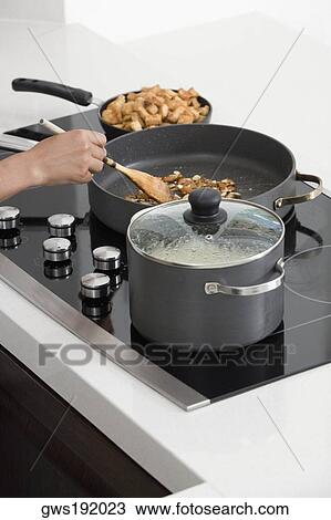 Close-up of a person's hand preparing food in the kitchen View Large Photo Image Stock Image - Close-up of a person's hand preparing food in the kitchen. Fotosearch