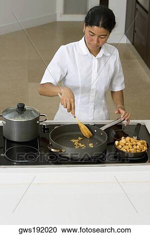High angle view of a maid preparing food in the kitchen View Large Photo Image Stock Image - High angle view of a maid preparing food in the kitchen. Fotosearch