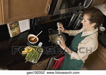 High angle view of a senior woman preparing noodles in the kitchen View Large Photo Image Stock Image - High angle view of a senior woman preparing noodles in the kitchen. Fotosearch