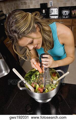 High angle view of a young woman preparing salad in the kitchen View Large Photo Image Stock Image - High angle view of a young woman preparing salad in the kitchen. Fotosearch