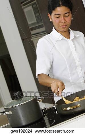 Maid preparing food in the kitchen View Large Photo Image Picture - Maid preparing food in the kitchen. Fotosearch