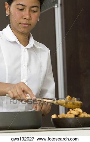 Stock Photo - Maid preparing food in the kitchen. Fotosearch