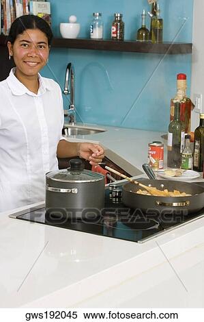 Portrait of a maid preparing food in the kitchen and smiling View Large Photo Image Stock Photography - Portrait of a maid preparing food in the kitchen and smiling. Fotosearch