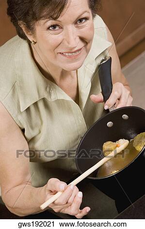 Portrait of a senior woman cooking corn soup View Large Photo Image Stock Image - Portrait of a senior woman cooking corn soup. Fotosearch