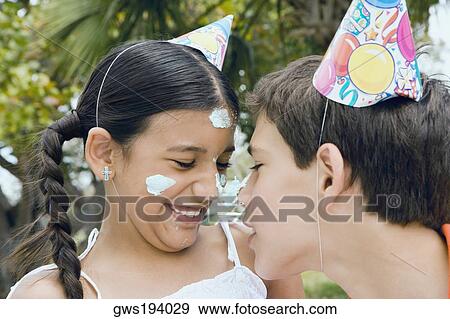 Close-up of a boy and his sister balancing a cake between their noses View Large Photo Image Stock Photo - Close-up of a boy and his sister balancing a cake between their noses. Fotosearch