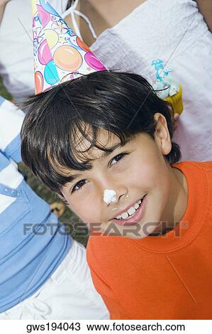 Close-up of a boy smiling with cake on his nose View Large Photo Image Stock Image - Close-up of a boy smiling with cake on his nose. Fotosearch