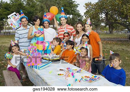 Family friends celebrating a birthday party with their children View Large Photo Image Stock Photo - Family friends celebrating a birthday party with their children. Fotosearch