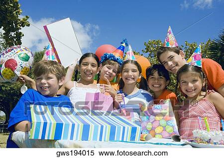 Group of children celebrating a birthday party View Large Photo Image Stock Photography - Group of children celebrating a birthday party. Fotosearch