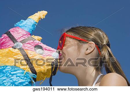 Low angle view of a girl kissing a rocking horse View Large Photo Image Stock Image - Low angle view of a girl kissing a rocking horse. Fotosearch