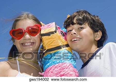 Portrait of a girl and her brother smiling with a rocking horse View Large Photo Image Stock Image - Portrait of a girl and her brother smiling with a rocking horse. Fotosearch