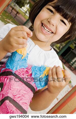 Portrait of a girl sitting on a rocking horse and smiling View Large Photo Image Picture - Portrait of a girl sitting on a rocking horse and smiling. Fotosearch